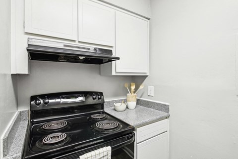 Modern and fully-equipped kitchen area at Pine Village North in Smyrna, GA